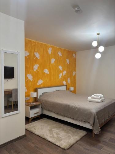 a bedroom with a bed and a wall with butterflies at Casa Seren in Corabia