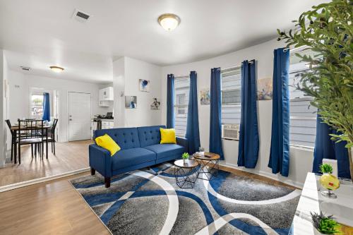 a living room with a blue couch and a table at Fun Family getaway - NYC & NWK w free parking in Newark