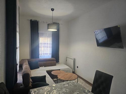 a living room with a couch and a table at Apartmani Rekovic in Kravlja