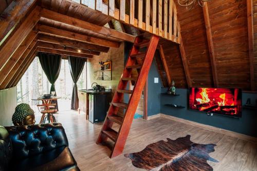 a living room with a staircase and a fireplace at Hotel Fazenda Gabro - Arvoredo in Apiaí