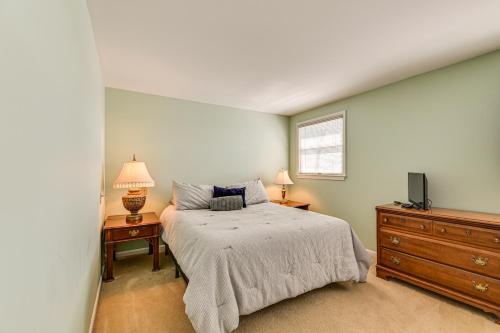 a bedroom with a bed and a dresser and a tv at Lakefront Canandaigua Home with Dock and Kayak! in Canandaigua