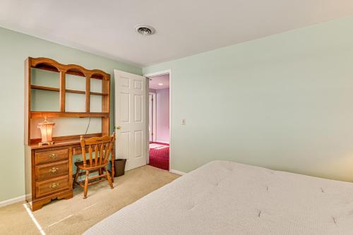 a bedroom with a desk and a bed and a chair at Lakefront Canandaigua Home with Dock and Kayak! in Canandaigua