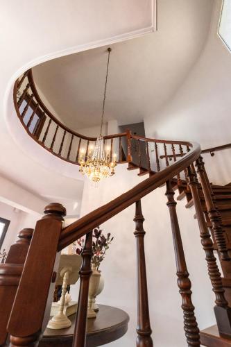 a circular staircase with a circular mirror on the ceiling at Villa Mitsekou in Prinos