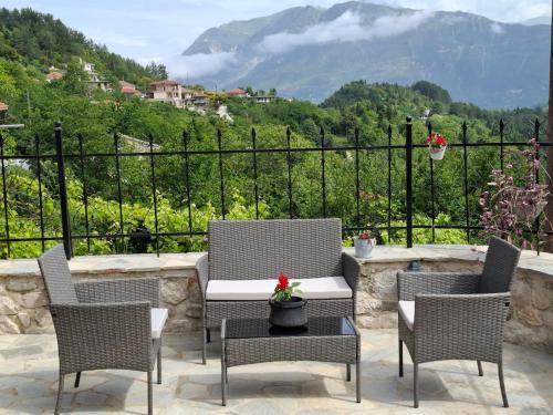 a patio with three chairs and a table with a view at Elen's Suites Pramanta in Pramanta