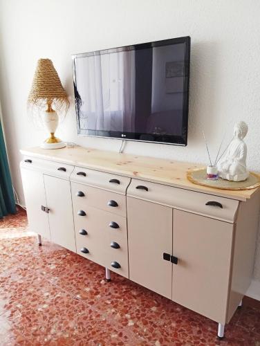 a dresser with a tv on top of it at El suéño de Fondón in Fondón