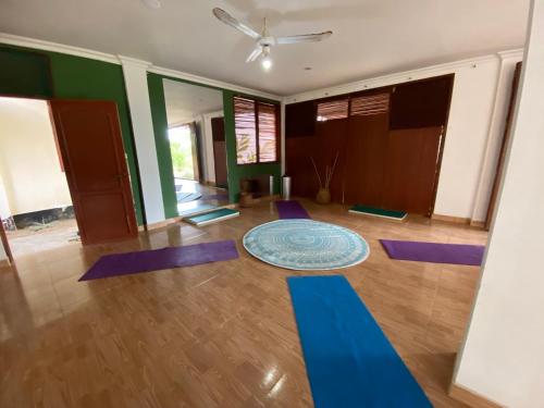 a yoga room with purple mats on the floor at Coccoloba Beach Hostel in Dibulla