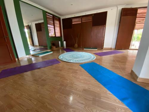 a yoga room with purple mats on the floor at Coccoloba Beach Hostel in Dibulla