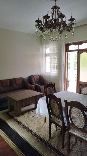 a living room with a table and a couch at Guest house maka in Gonio