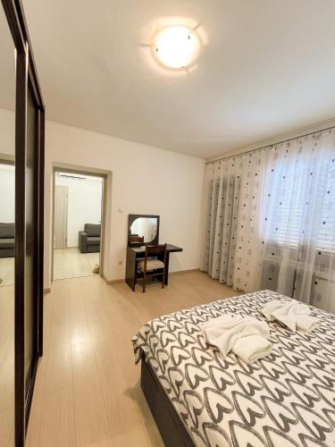 a bedroom with a bed and a desk in it at Apartment Trsina in Rakalj
