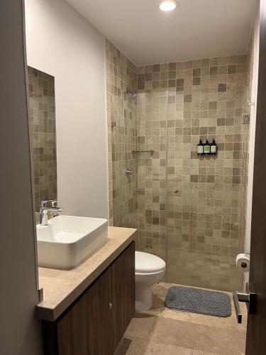 a bathroom with a sink and a toilet and a shower at Luxury, security, infinity pool, view, centric in Miravalle