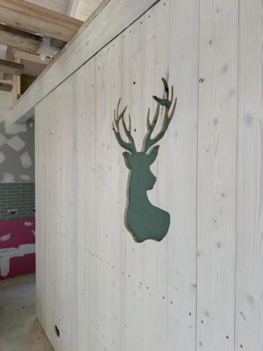 a wooden wall with a reindeer on it at LESNA 41a - Nowoczesna Stodoła w stylu skandynawskim in Dobrcz