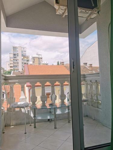 a view of a balcony with a table and chairs at Stars Aspava Blue HOSTEL in Podgorica