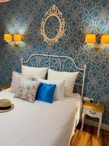 a bedroom with a bed with a blue wall at Perla Hvar ApartHotel in Ivan Dolac