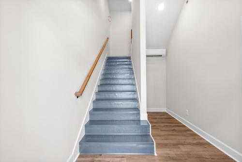 a staircase in a house with blue stairs at The Crash Pad at The Spot on 281 Liberty Pkwy in Clarksville