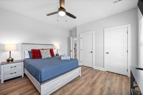 a bedroom with a bed and a ceiling fan at The Crash Pad at The Spot on 281 Liberty Pkwy in Clarksville