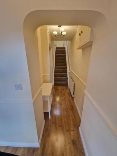 a hallway with a staircase in a house with a stair case at Lake View Retreat in Enniskillen