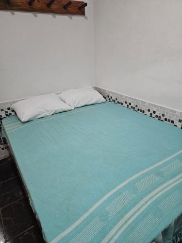 a large bed in a room with a blue mattress at Quarto - suíte pequi - Centro Histórico da Cidade de Goiás in Goiás