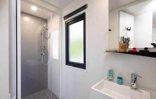 a bathroom with a shower and a sink and a window at Camping 3 étoiles - Piscine - ccbb0if in Montpon-Ménestérol