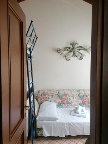 a bedroom with a bed with a ladder next to it at [Exclusive Villa Punta San Vigilio] in Garda