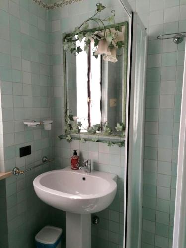 a bathroom with a sink and a mirror at [Exclusive Villa Punta San Vigilio] in Garda