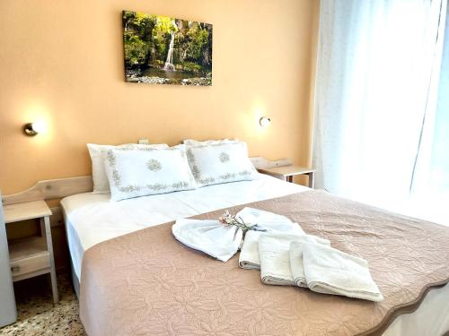 a hotel room with a bed with towels on it at Villa Ermioni Studios in Limenas