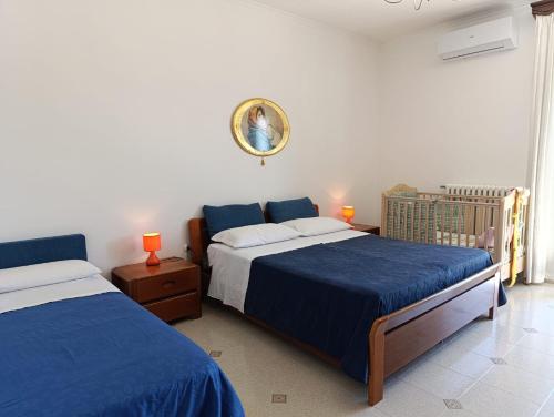 a bedroom with two beds and a crib at Le Rondini in Trani