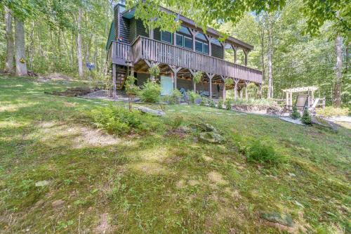 a large house on a hill in the woods at 4 Mi to Lake Santeetlah Cabin with Deck and Views in Robbinsville