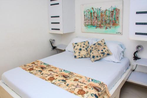 a bedroom with two beds and a painting on the wall at Ocean view - 77Rentals in Cartagena de Indias