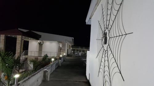 a spiderweb on the side of a building at night at Pamo Hotel and Restaurants in Kitwe