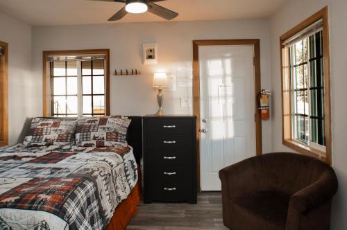 a bedroom with a bed with a dresser and a chair at Baby Bear - A delightful studio style property in the perfect central location! in Big Bear Lake