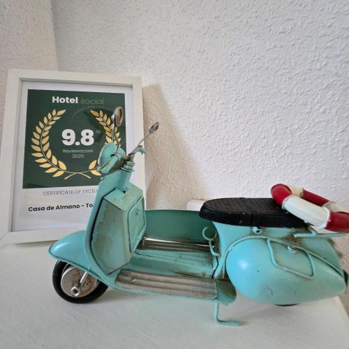 a small blue scooter parked next to a sign at Casa de Almano - Torremolinos direct on beach in Torremolinos