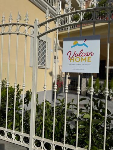 a white fence with a sign on it at VulcanHome in Cercola