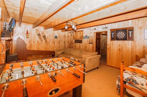a living room with a large chess board in the middle at Big Wood Pines - Relaxing home with a large fenced yard for your furry friends to enjoy! in Big Bear City