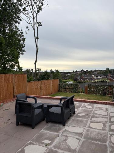 a patio with two chairs and a table at Near Birmingham - Stylish and Peaceful - Private Parking in Birmingham