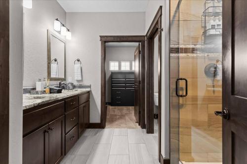 a bathroom with a sink and a glass shower at Winston's Luxurious Retreat in Coeur d'Alene
