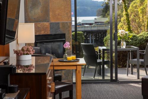 a patio with a table and chairs and a balcony at Brentwood Bay Resort & Spa in Brentwood Bay