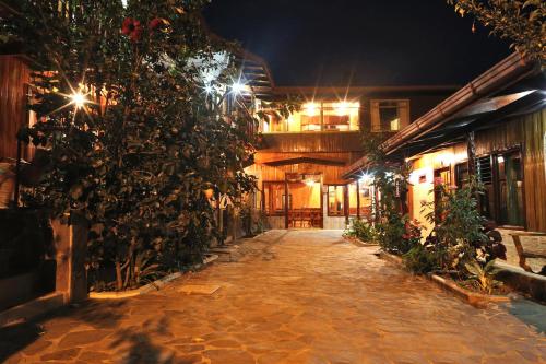 an alley at night with lights on a building at Hotel El Atardecer in Monteverde Costa Rica