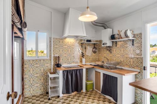 a kitchen with a sink and a counter top at Mola Mola Sagres in Sagres