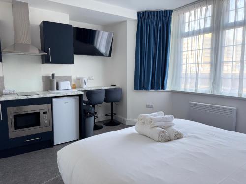 a bedroom with a bed with towels on it at Aaron Wise - 09 Coldstream Studios in Cardiff