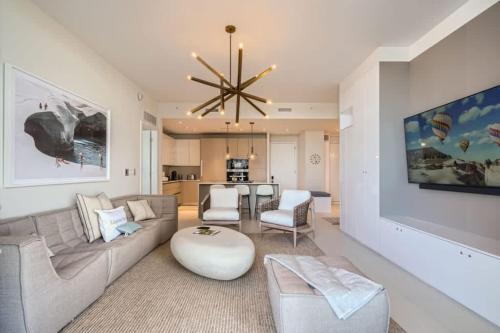 a living room with a couch and a table at Amrit Resort - Bask in Rare Oceanfront Luxury with Stunning Views in Riviera Beach
