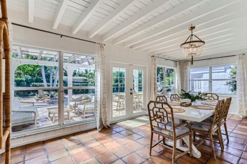 a dining room with a table and chairs at The Glenn House - Gather Poolside in a Breezy South End Getaway in West Palm Beach