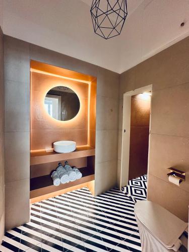 a bathroom with a sink and a mirror at Pink Pineapple in Athens