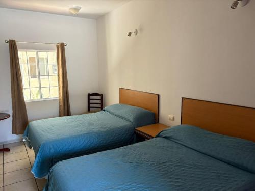 Postel nebo postele na pokoji v ubytování Bugambilias Hotel Hacienda