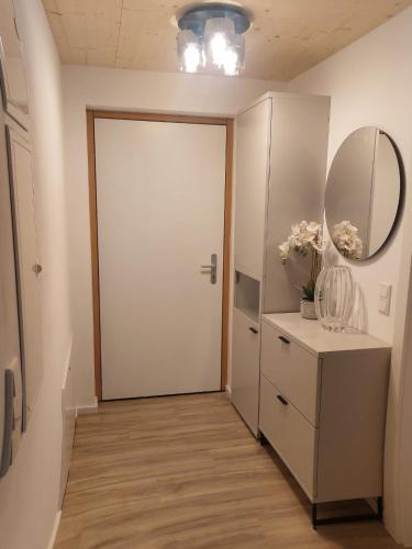a hallway with a white door and a mirror at Schafberg Luxury Apartment in St. Wolfgang