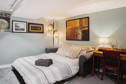 a bedroom with a bed next to a desk and a desk at No Car Needed - N Beacon Hill Beauty in Seattle