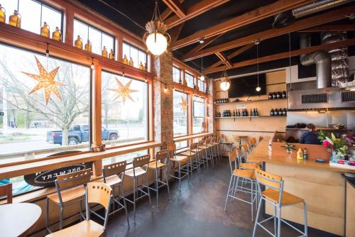 a restaurant with tables and chairs and a bar at No Car Needed - N Beacon Hill Beauty in Seattle