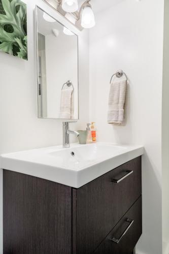 a bathroom with a white sink and a mirror at No Car Needed - N Beacon Hill Beauty in Seattle