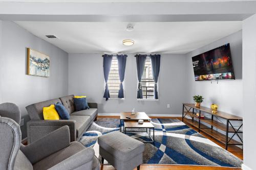 una sala de estar con un sofá y una mesa en Peaceful Hideaway - NYC & NWK with free parking, en Newark