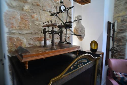 a shelf on top of a fireplace in a room at Axilleion Boutique Hotel in Ermoupoli