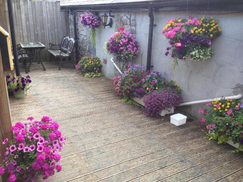 a bunch of flowers on a wooden deck at The Bugle Inn in St Austell